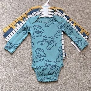 NWT Carter’s baby size 9 months four pc. Long sleeve onesies